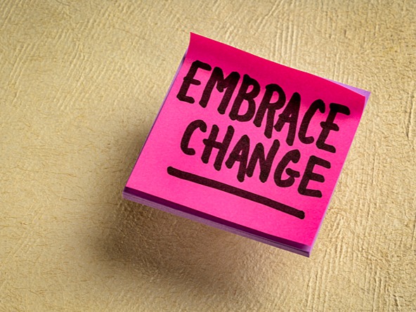 Sticky note spelling 'embrace change'